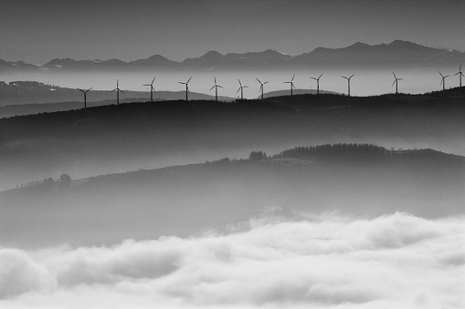 Mountain and mist landscape, wind turbines, camino de santiago, Lugo province, Galicia, Spain. Black and white view