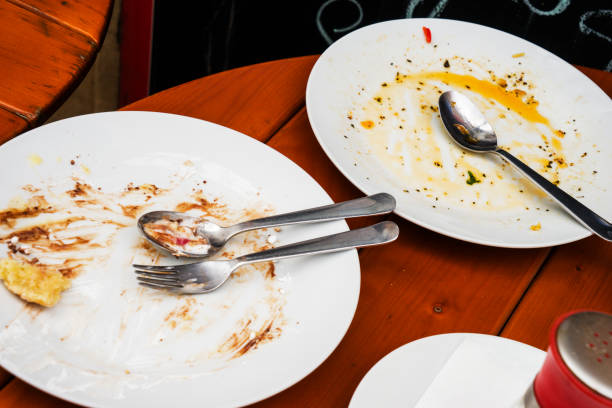 istock white plate and fork with leftover food on the table 1469519518
