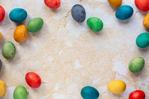 Easter eggs in many colors on a yellow background.
