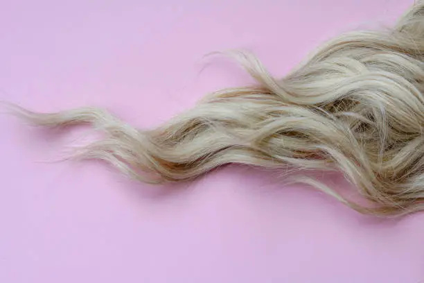 Photo of Lock of hair on colorful background