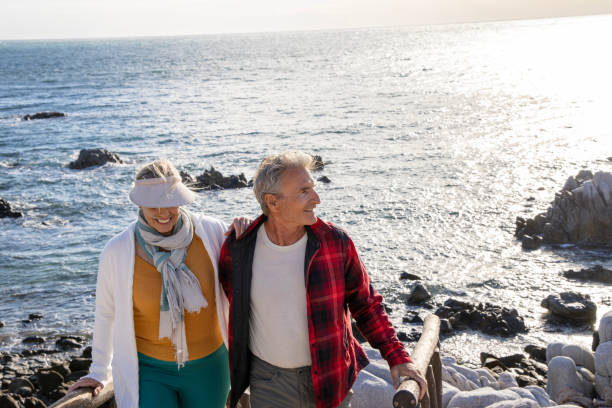 istock Mature couple ascend steps from rocky beach point 1469526805