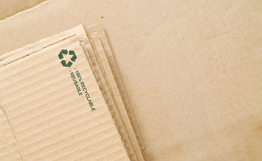 Cardboard with recycling sign. Eco-friendly recycled material