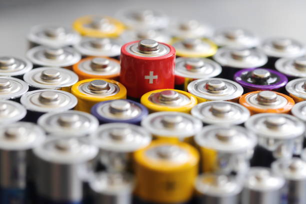 many round batteries and one red battery stock photo