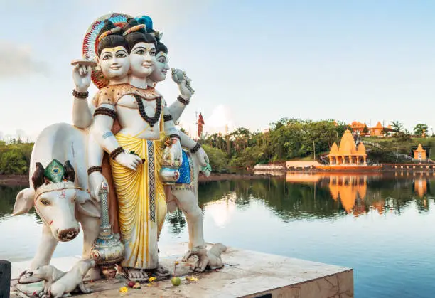 Three gods Dattatreya Trimurti (Divine Trinity) Sculpture in Grand Bassin Temple (Ganga Talao) on the lake bench - a sacred place for pilgrimage of Hindu people in district Savanne, Mauritius.