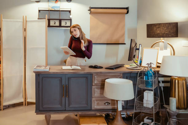 istock Woman Talking on Smartphone at Home Decoration Store 1469531433