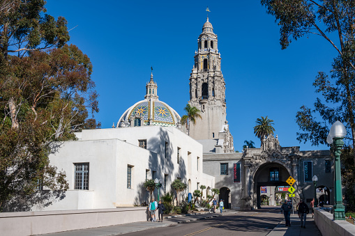 San Diego, California, USA - November 15, 2022:  Street in Balboa Park in San Diego with a view of the  ornate dome of the Museum of Us and the California Tower