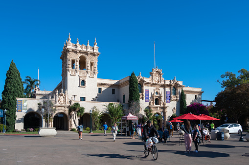 San Diego, California, USA - November 15, 2022: Group of tourists in front of Balboa Park's Visitor Center including The Prado restaurant offers historic charm in the center of San Diego's Balboa Park.