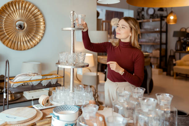 istock Woman Arranging Home Accessories in Home Decor Store 1469531683