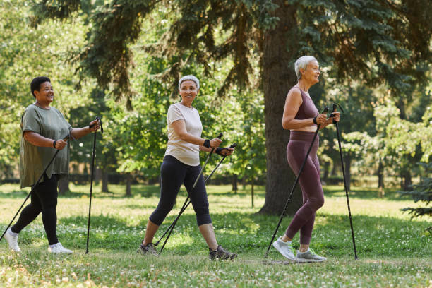 istock Side view senior women walking with poles in park 1469533778