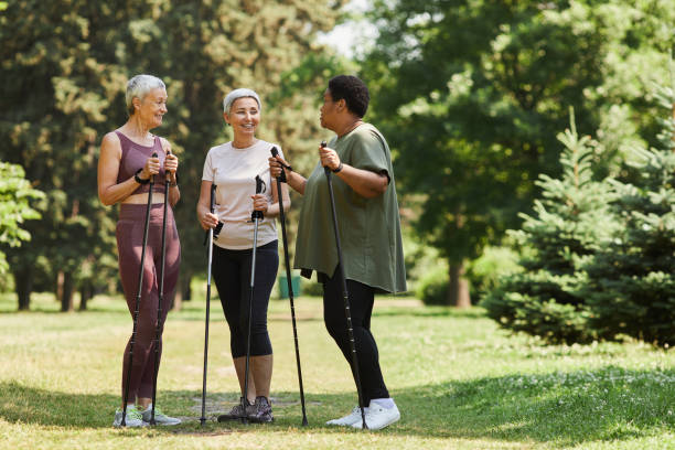 istock Active senior women with walking poles chatting outdoors and smiling 1469533792