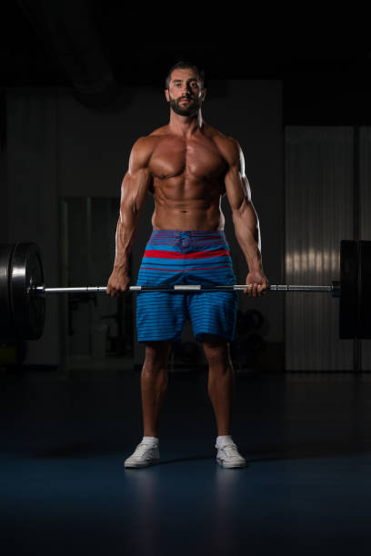 istock Bodybuilder Performing Back Exercising With Barbell In Gym 1469534590