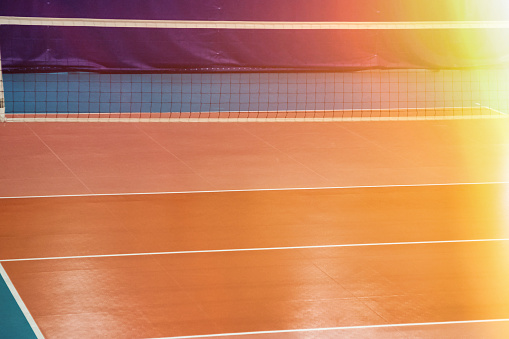 Sports image background: volleyball net in an old empty sports gym. Top view, backdrop for team volleyball game. Concept of getting sport, healthy lifestyle and team success. Copy ad text space