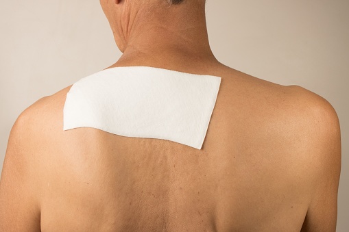 Man wearing a medicated patch for pain