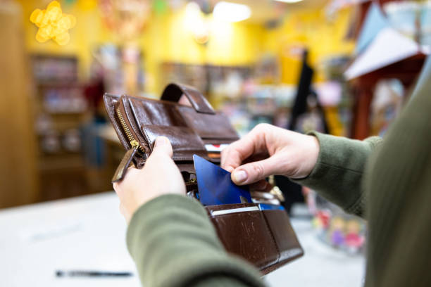 A young woman making a purchase at a small business with her credit card