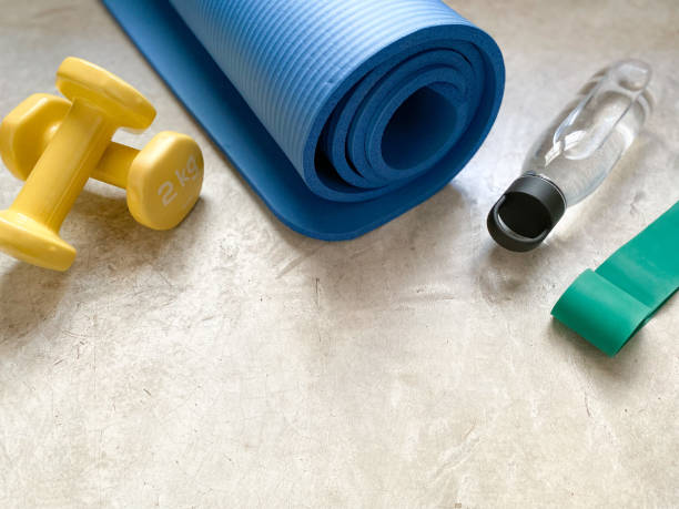 Background with dumbbells, mat, water bottle and resistance band
