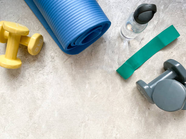 istock Background with dumbbells, mat, water bottle and resistance band 1469539163