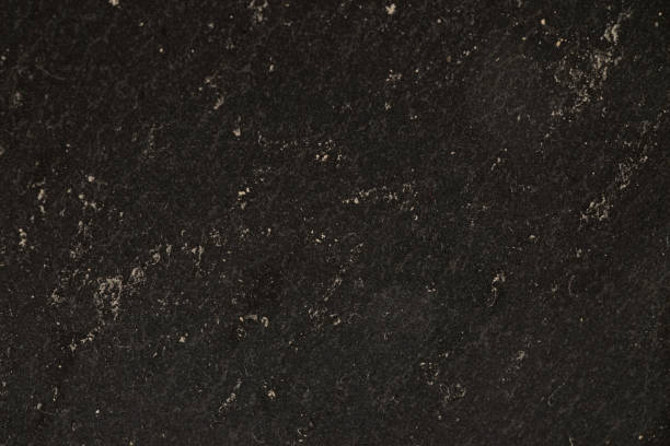 istock A black marbled stone with gold accents textured background 1469539192