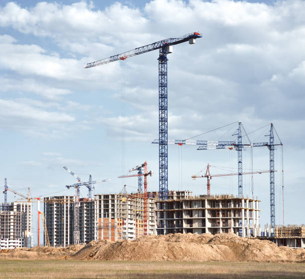 istock Tower cranes silhouettes and high-rise buildings under construction 1469539308