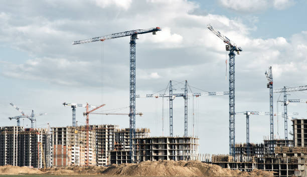 istock Tower cranes silhouettes and high-rise buildings under construction 1469539338