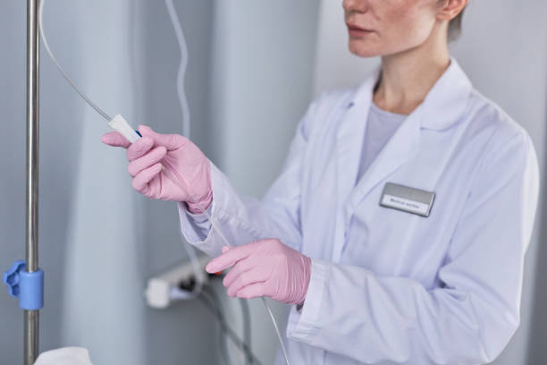 istock Nurse adjusting IV fluid setup in hospital 1469539640