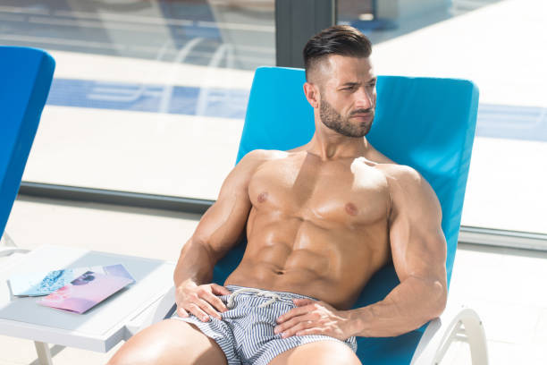 istock Man Resting On Sun Loungers By Swimming Pool 1469540431