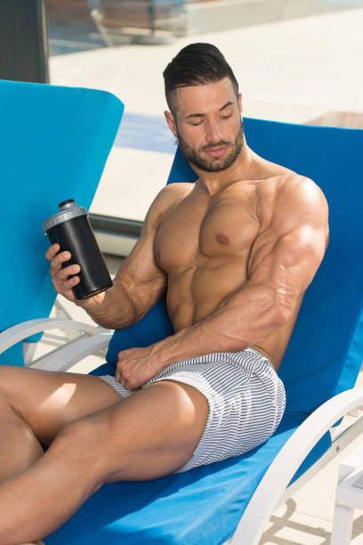 istock Athlete Resting on Lounger With Supplements and Shaker 1469540451