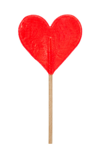 red heart shaped lollipop isolated on a white background