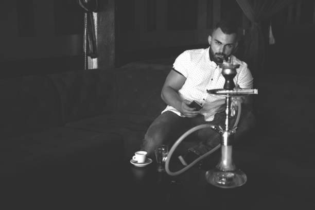 istock Man Smoking Shisha At Arabic Restaurant 1469542228