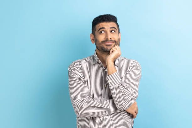 istock Businessman standing and looking away with thoughtful expression, imagining something pleasant. 1469544794