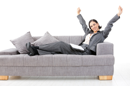 Excited happy young businesswoman sitting on sofa. Click here for more business images: