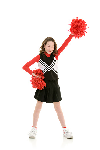 Beautiful cheerleader with pom poms jumping on white background
