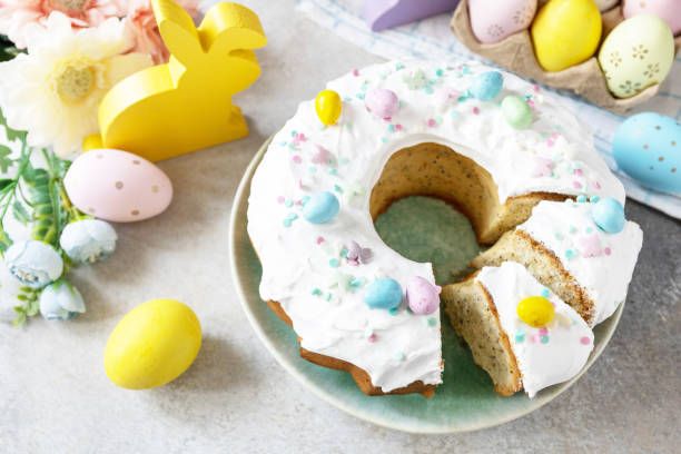 istock Happy Easter holidays, tasty dessert. Glazed easter lemon cake decorated with confectionery and mini chocolate eggs candy on gray stone background. 1469546455