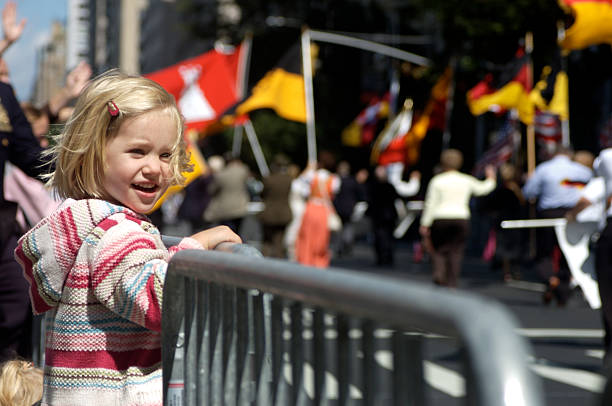 A young female enjoying a parade Little blond girl watches parade go by parade stock pictures, royalty-free photos & images