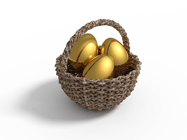 wooden basket with golden eggs stock photo