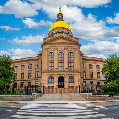 Historic Georgia State Capitol Building with Golden Dome on a day with dramatic clouds