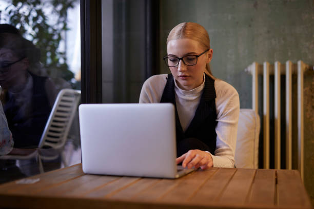 istock young lady working on computer at a stylish cafe 1469550081
