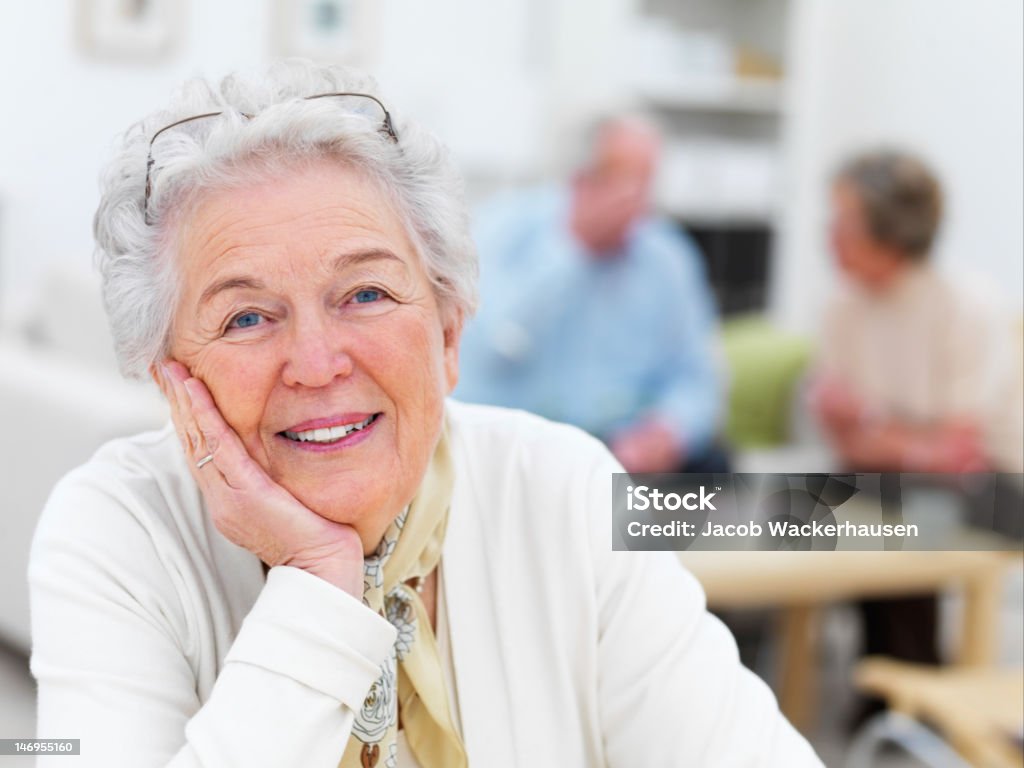 Close-up of a senior woman with friends in background Women Stock Photo