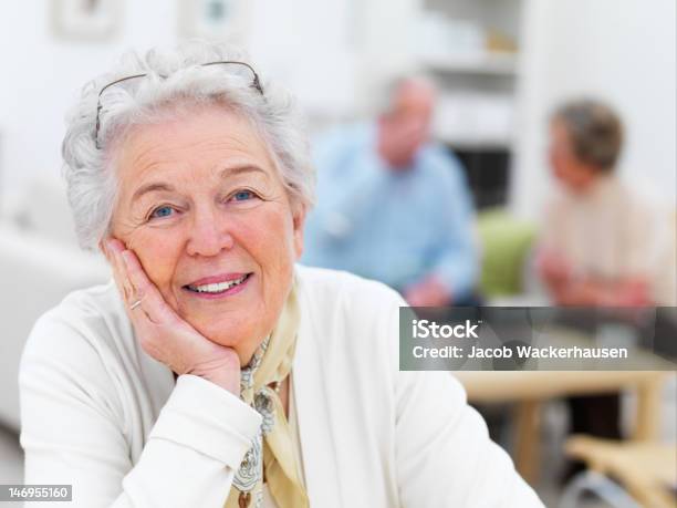 Closeup Of A Senior Woman With Friends In Background Stock Photo - Download Image Now