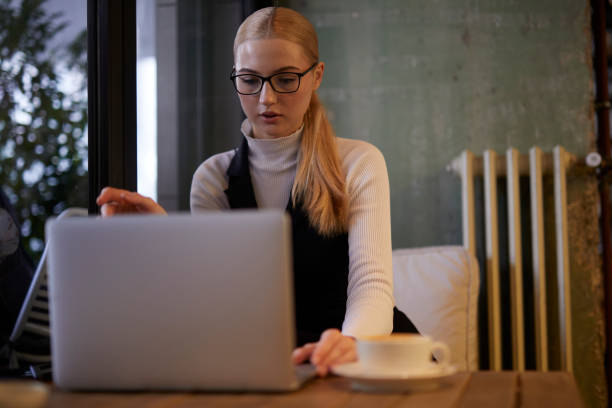 istock young lady working on computer at a stylish cafe 1469551958