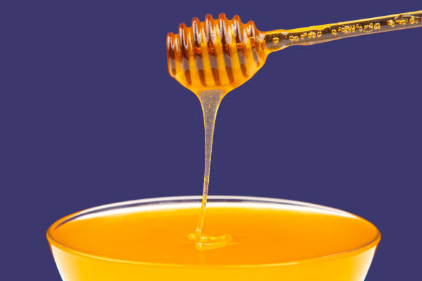 istock fresh fragrant honey drips from a spoon into a plate on a colored background. organic vitamin nutrition. dessert food 1469555889