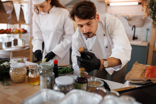 istock Young professional chef going over ingredients at small food home based store 1469560542