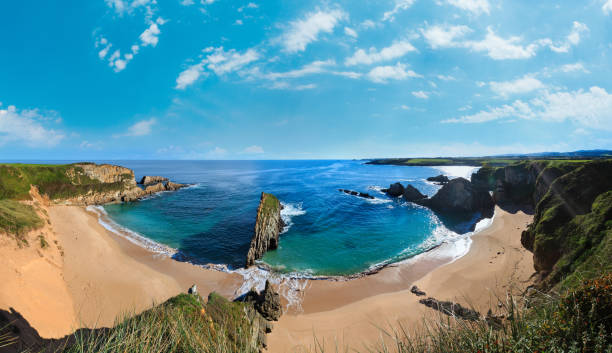istock Morning sandy Mexota beach with sunrays (Asturias, Spain). Spring Atlantic Ocean coastline panorama. 1469562974