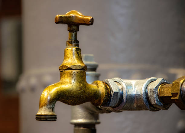 Vintage bathroom furniture. Old brass and bronze sewer pipes and faucets