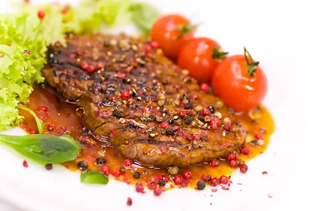 grilled peppercorn-steak with cherry tomato,corn salad.