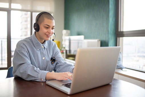 Happy young woman is enjoying working from home