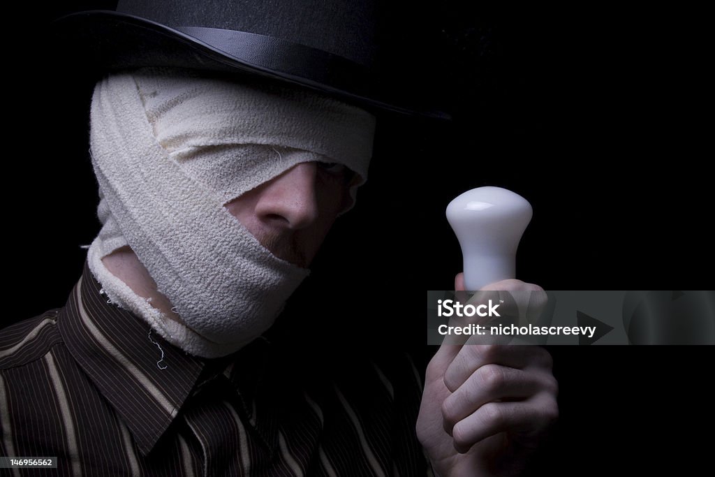 Ghetto Male A bandaged male holding a light bulb with an idea. Adult Stock Photo