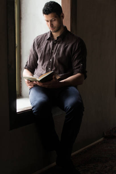 istock Young Muslim Guy Reading The Koran 1469566454