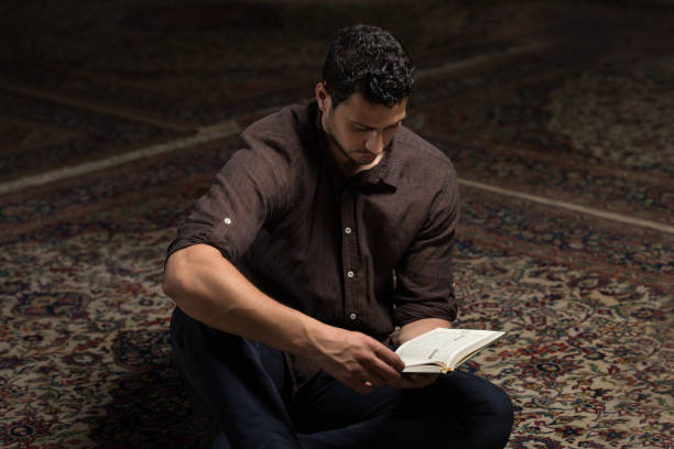 istock Arabic Muslim Man Reading Holy Islamic Book Koran 1469566459