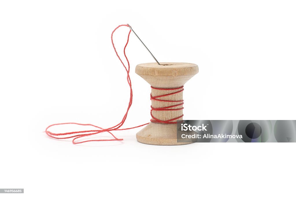 red thread a needle and reel red thread a needle, reel of thread Art And Craft Stock Photo