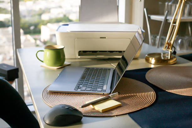 Working from home equipment Desk with working from home equipment like laptop and printer computer printer stock pictures, royalty-free photos & images